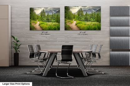 a dining room table with chairs and two pictures on the wall