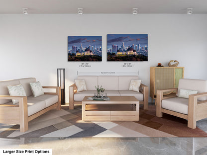 a living room filled with furniture and a painting of a city