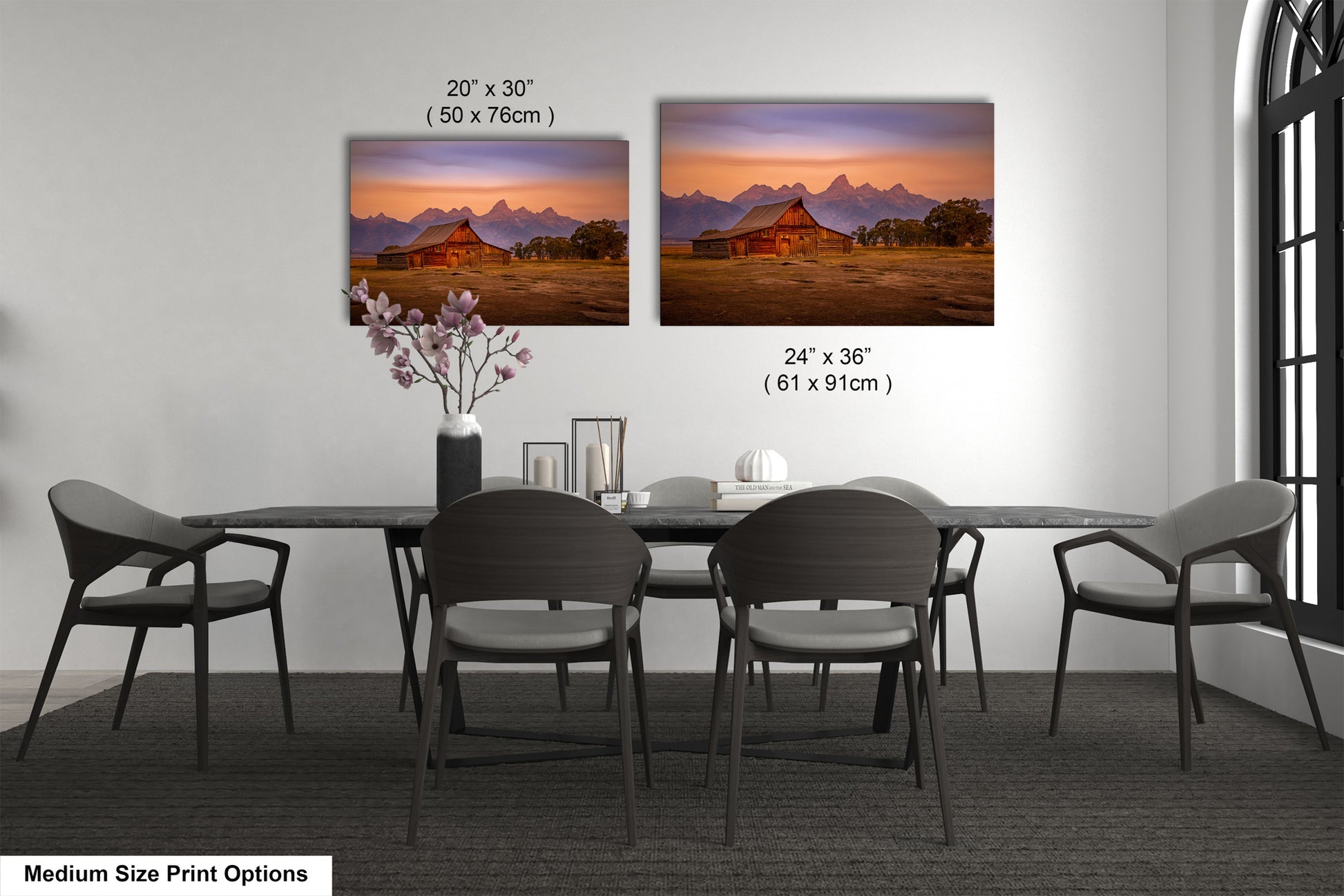 a dining table with four chairs and a vase of flowers