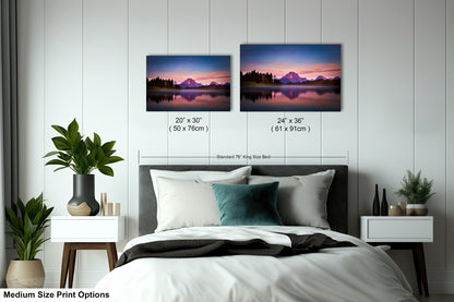 a bedroom with a bed and two pictures on the wall