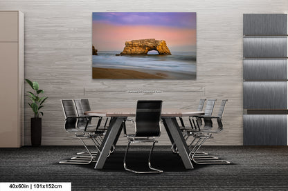a dining room table with chairs and a painting on the wall