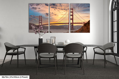a dining room table with chairs and a painting of the golden gate bridge