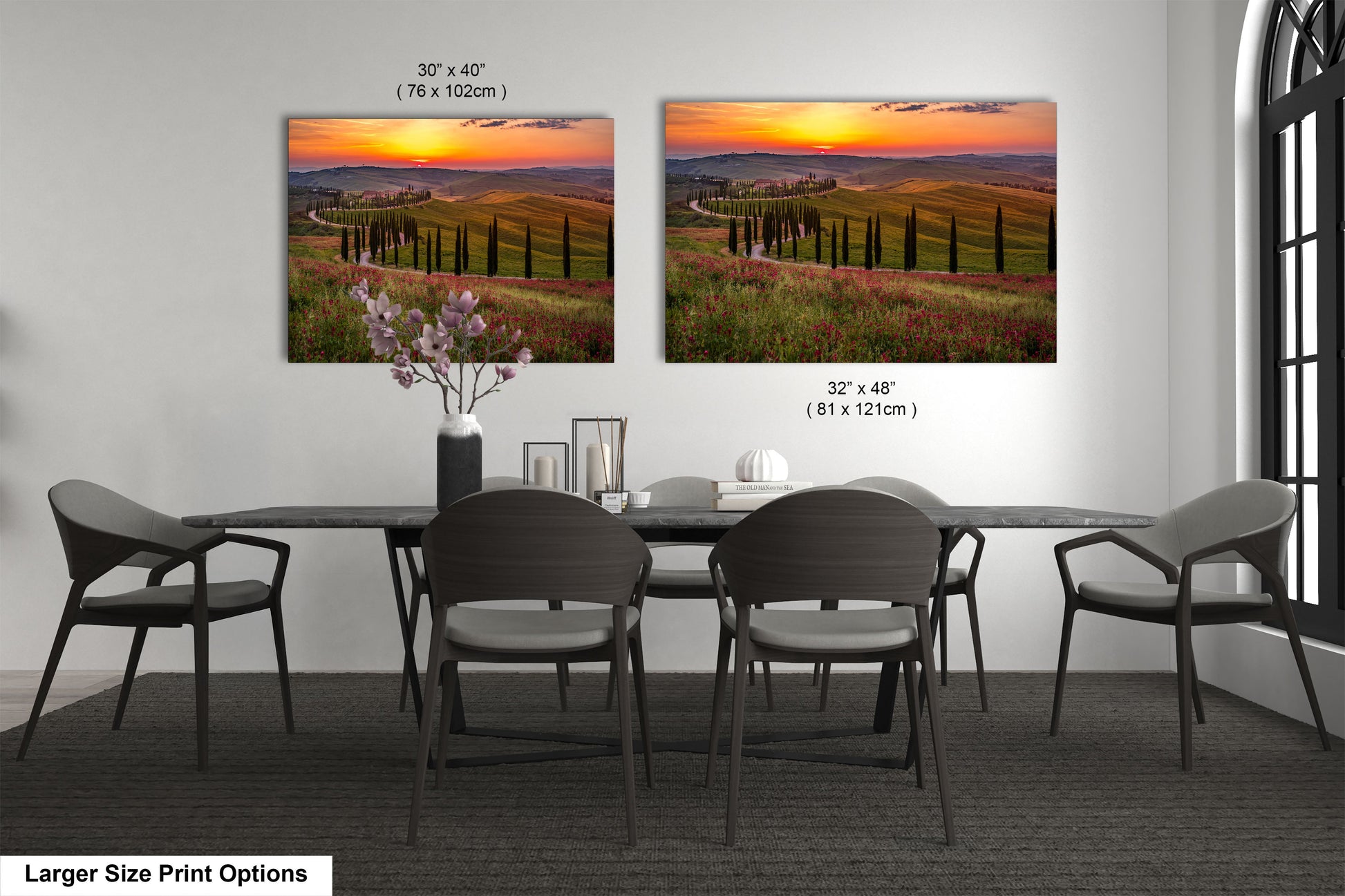 a dining room table with four chairs and two pictures on the wall