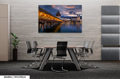 a dining room table with chairs and a painting on the wall