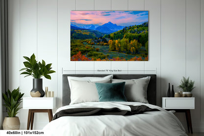 a bedroom with a bed and a painting on the wall