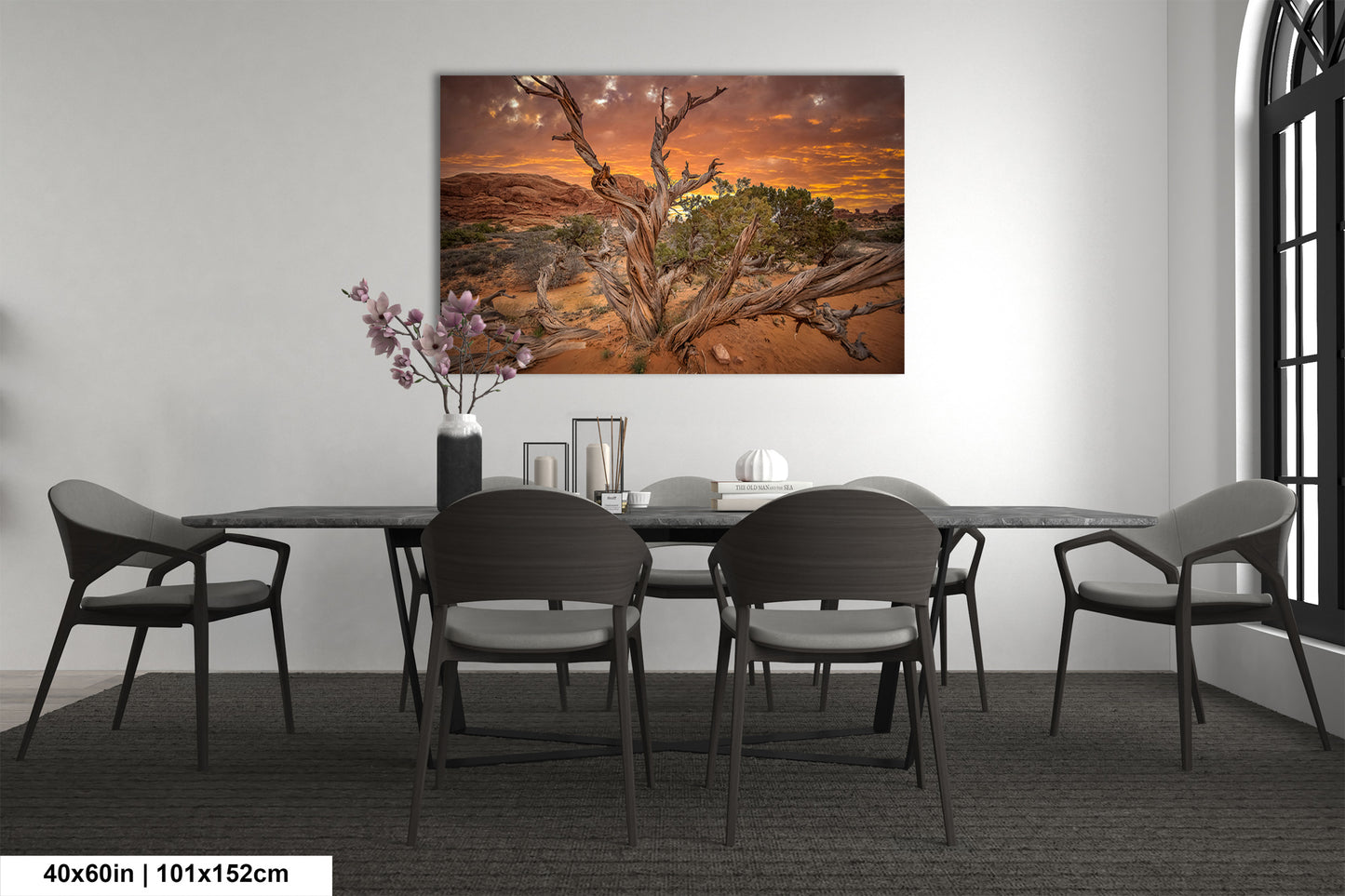 a dining room table with chairs and a painting on the wall