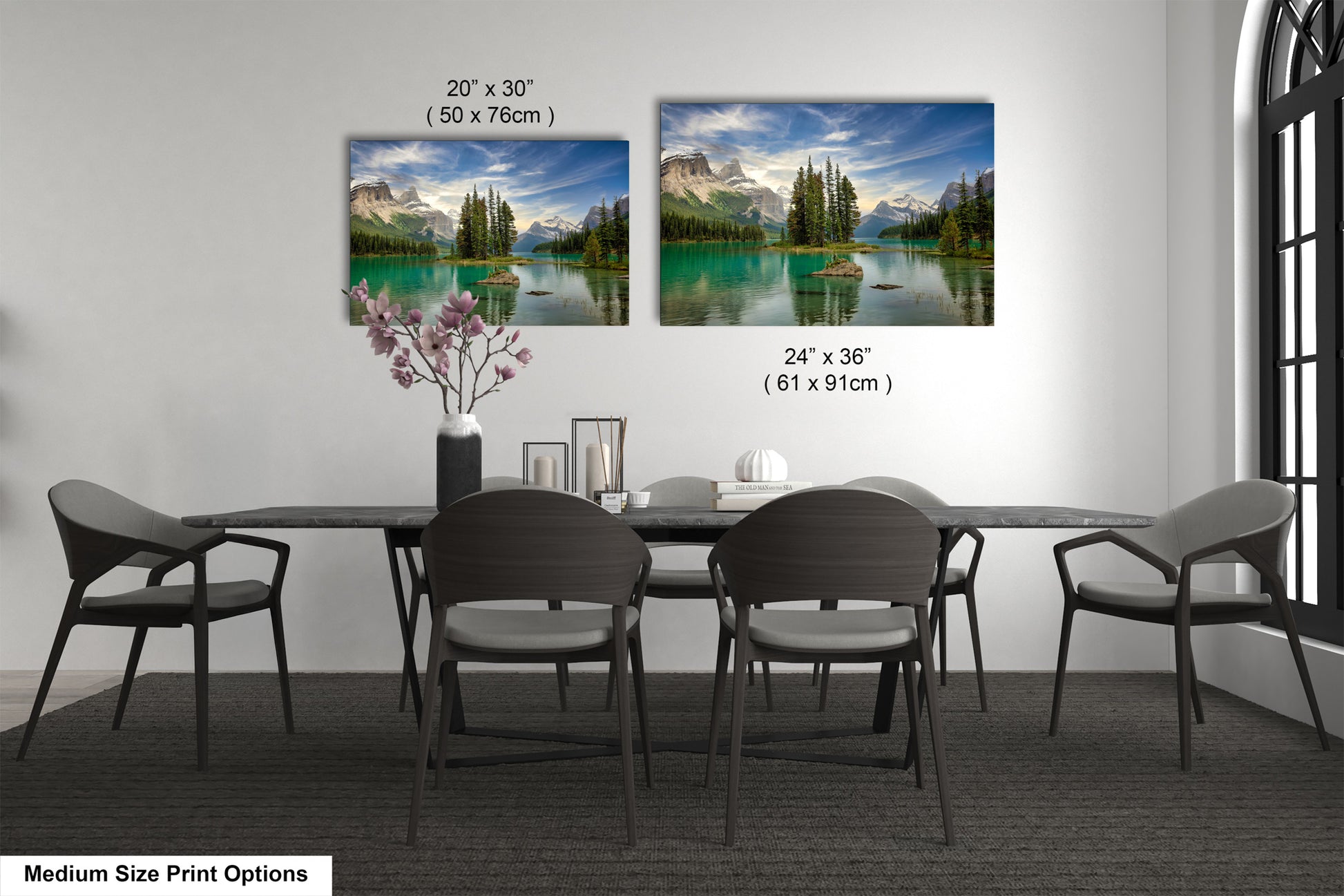 a dining table with four chairs and a vase with flowers