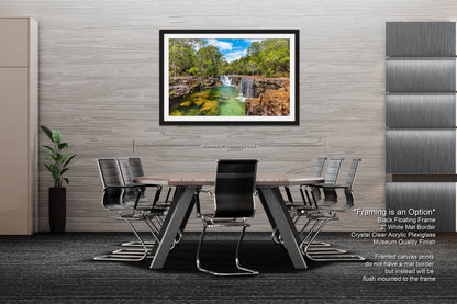 a dining room table with chairs and a painting of a waterfall