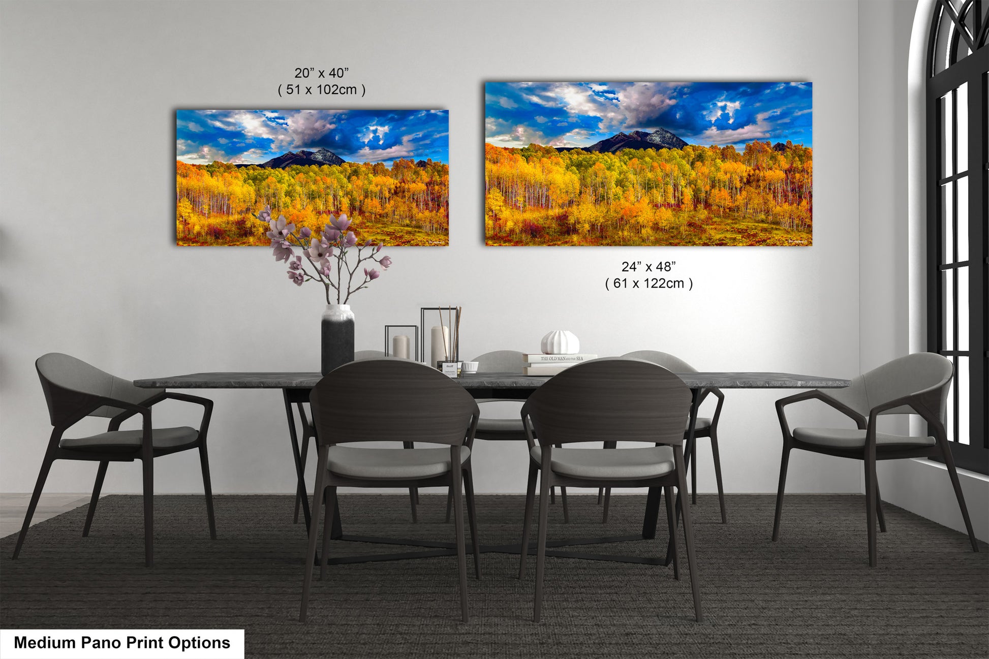 a dining room table with four chairs and a painting on the wall