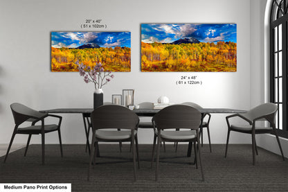 a dining room table with four chairs and a painting on the wall