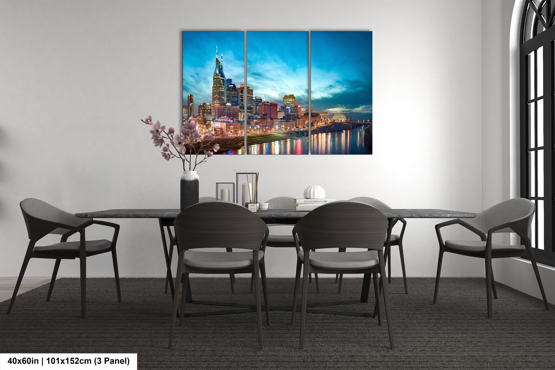a dining room table with chairs and a painting on the wall