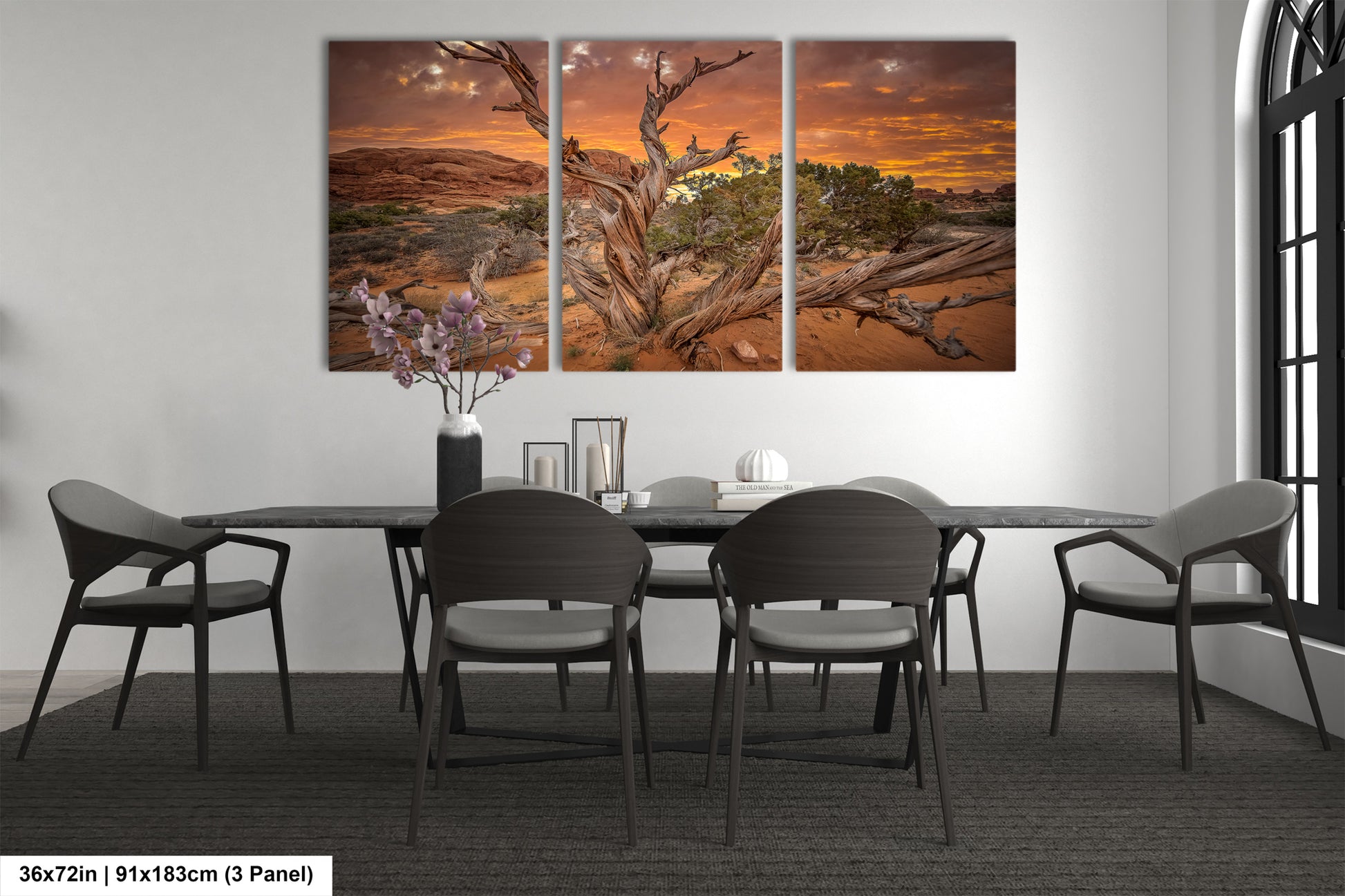 a dining room table with chairs and a painting on the wall