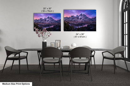a dining table with four chairs and a vase with flowers