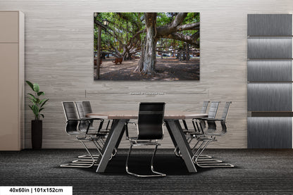 a dining room table with chairs and a painting of a tree