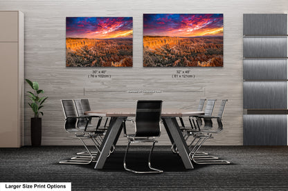 a dining room table with chairs and two pictures on the wall