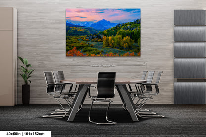 a painting of a mountain scene with a table and chairs