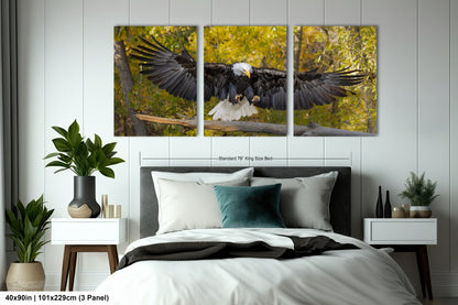 a bedroom with a bed and two paintings on the wall