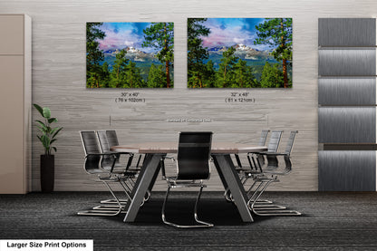 a dining room table with chairs and two pictures on the wall