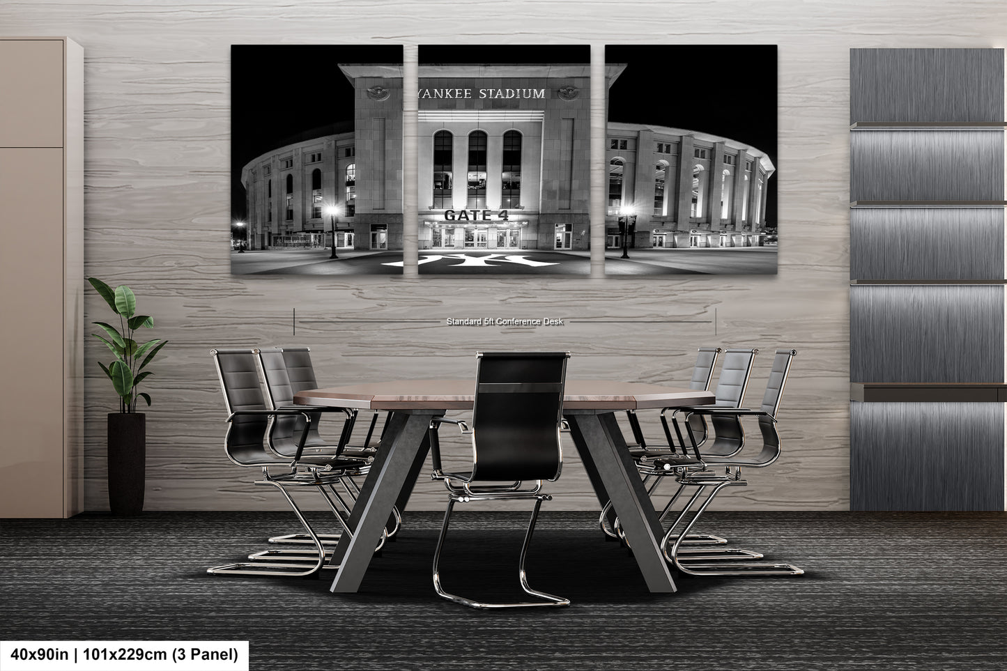 A modern office space with a large black and white photograph of Yankee Stadium as the focal point. The photograph is mounted on the wall above a conference table with chairs.