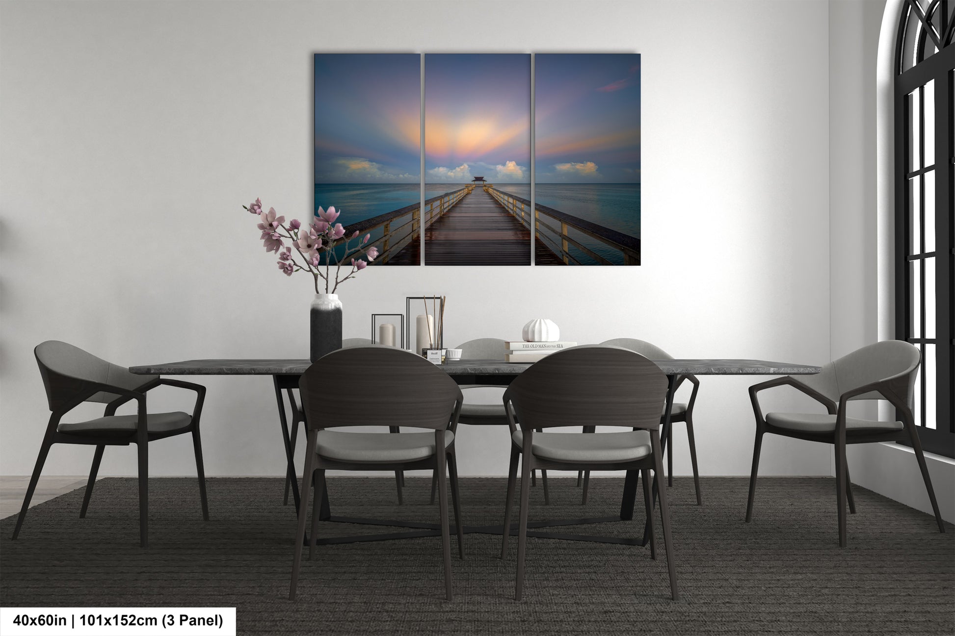 a dining room table with chairs and a painting on the wall