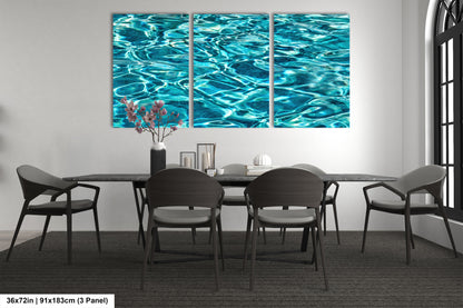 a modern dining room with a large, three-panel artwork depicting a serene water scene on the wall. The artwork is surrounded by a minimalist design, with a black table and chairs, a vase of flowers, and a few decorative items on the table.