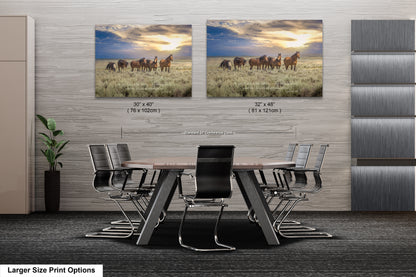 a dining room table with chairs and two pictures of horses on the wall