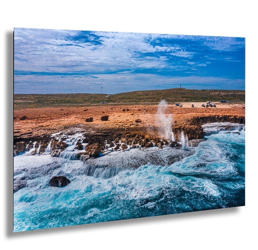 a large body of water near a rocky shore