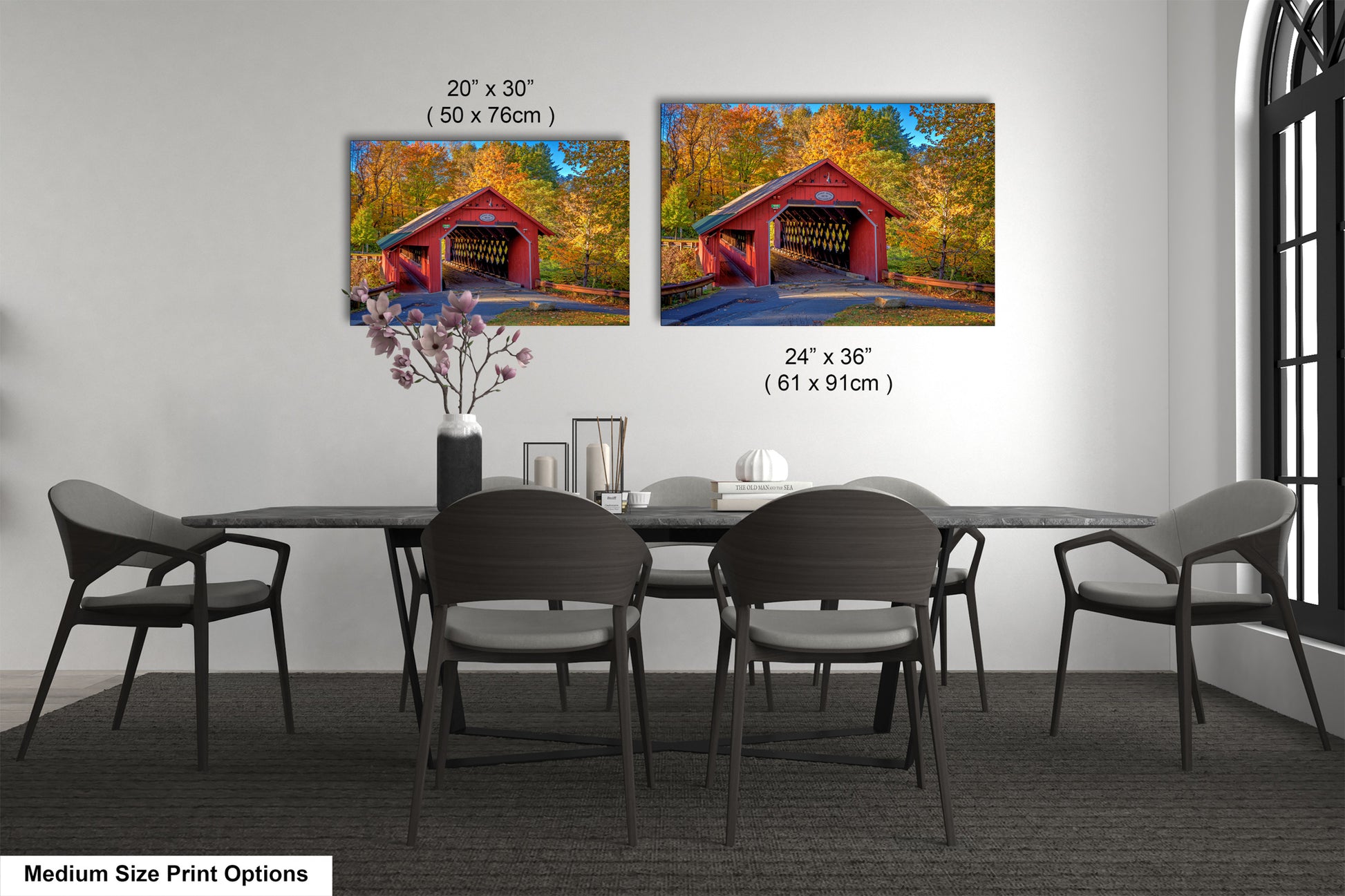 a dining room table with chairs and a painting of a covered bridge