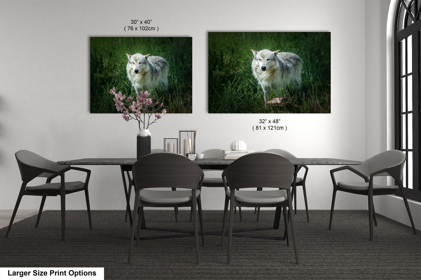 a dining room table with chairs and two pictures on the wall