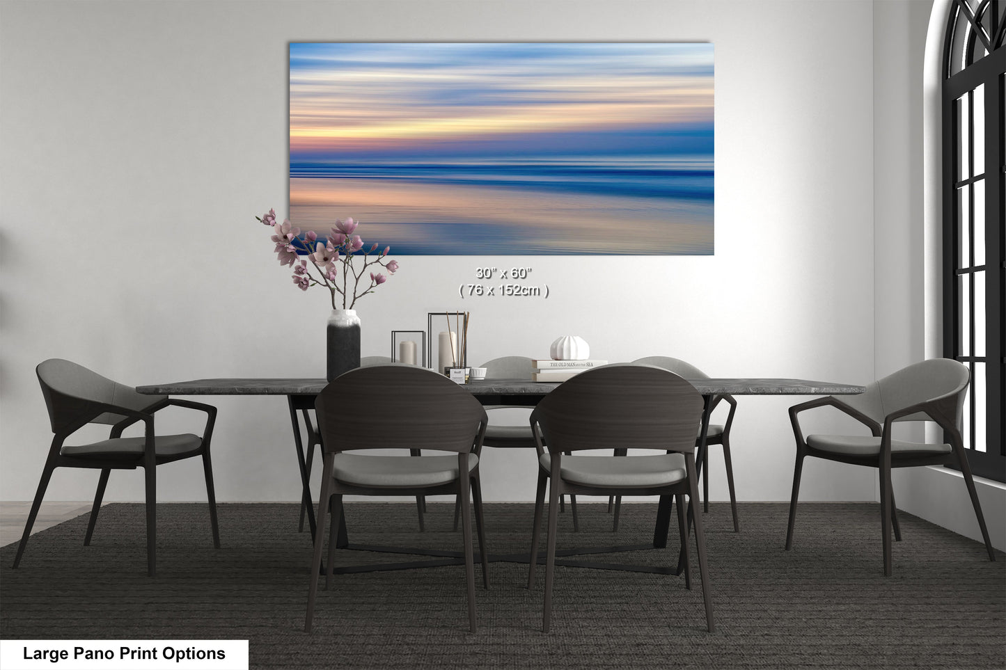 a dining room table with chairs and a vase of flowers