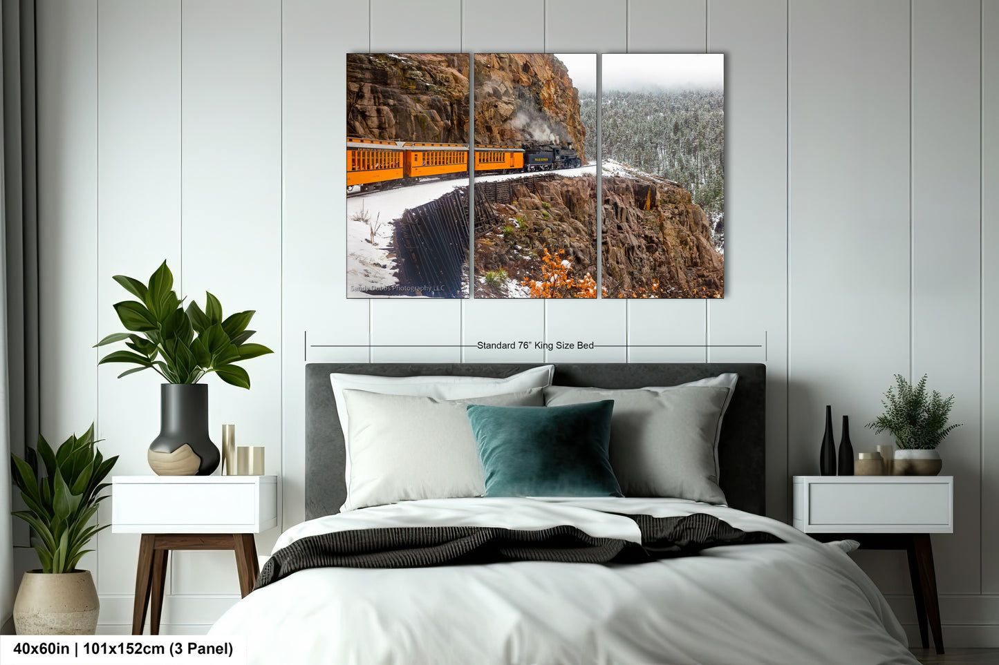a bed room with a neatly made bed and a painting on the wall