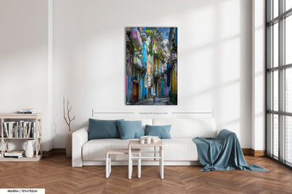 a living room with a white couch and a painting on the wall