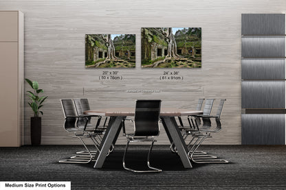 a dining room table with chairs and two pictures on the wall