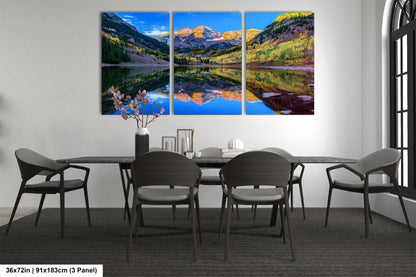 a dining room table with four chairs and a painting on the wall