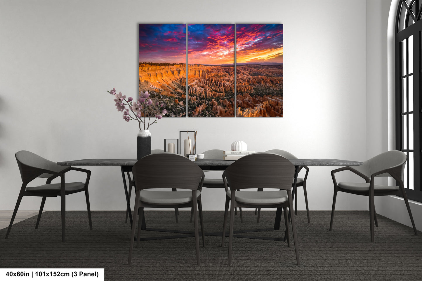 a dining room table with chairs and a painting on the wall