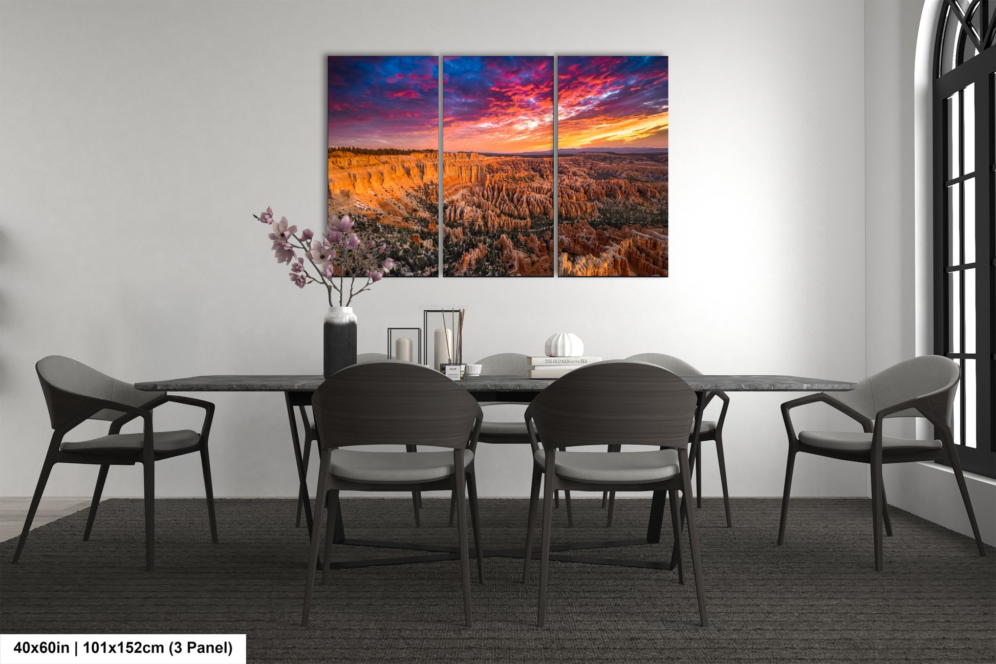 a dining room table with chairs and a painting on the wall