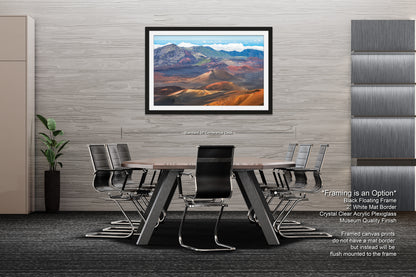 a modern office space with a large framed landscape painting hanging on the wall above a wooden table surrounded by black chairs.