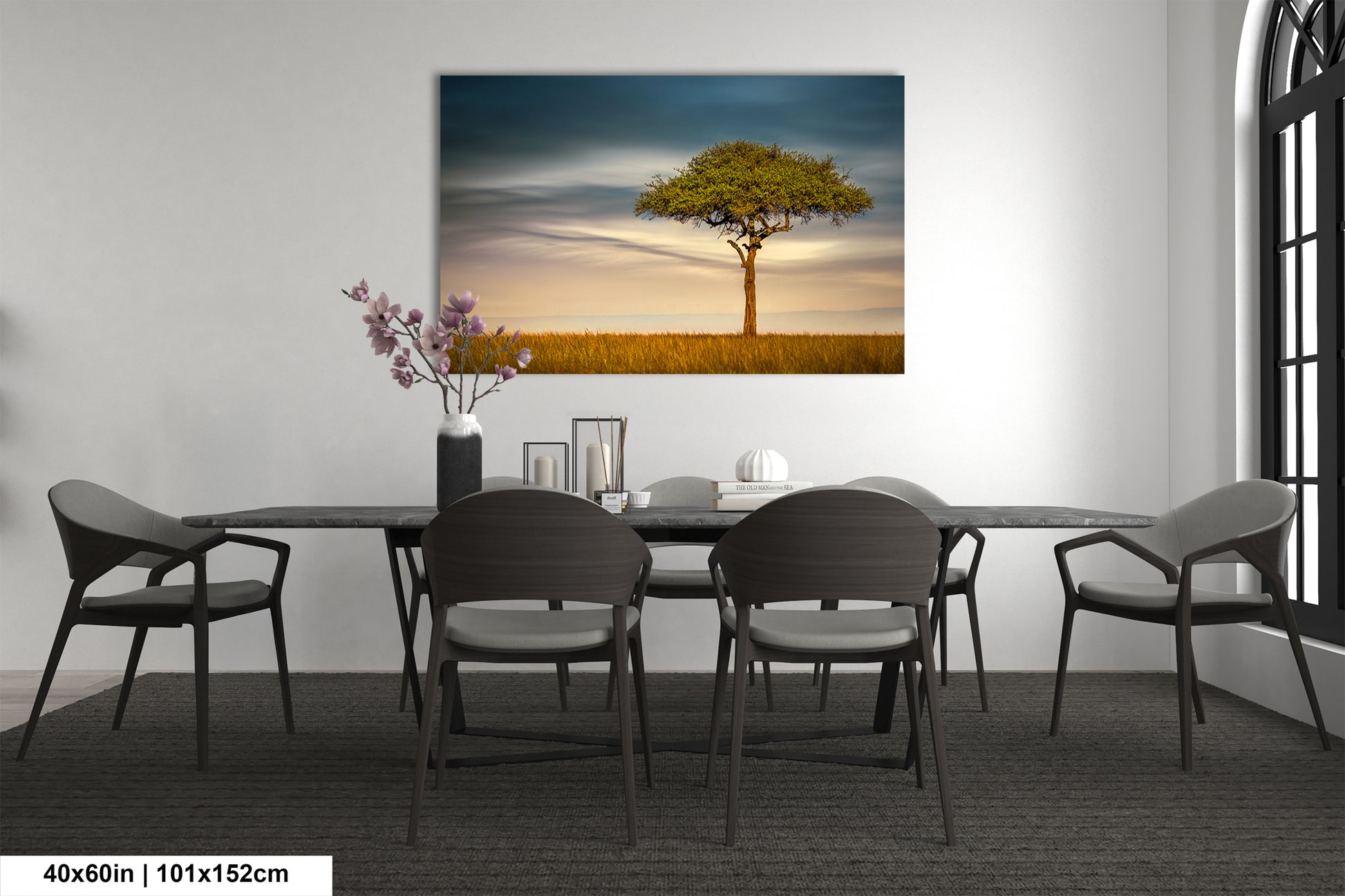 a dining room with a table and chairs and a painting on the wall