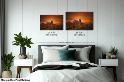 a bed with two pictures on the wall above it