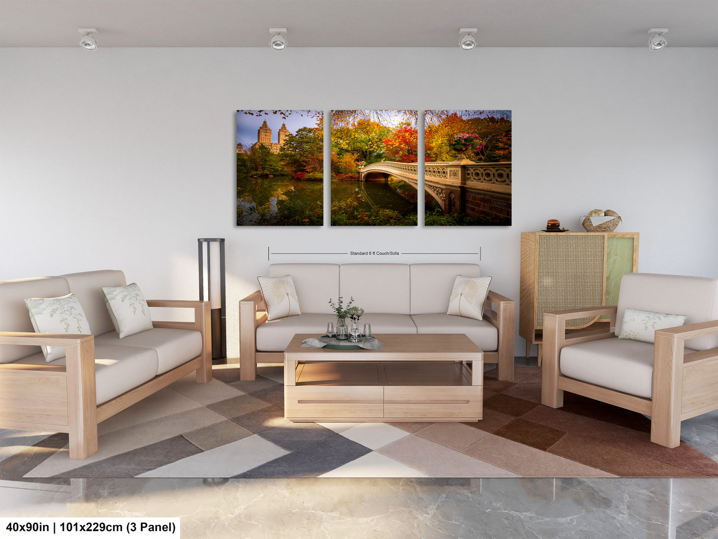 The image is a modern living room with a large, three-panel landscape painting depicting a scenic view of Central Park in New York City. The painting features a bridge, trees, and a lake, creating a serene and picturesque atmosphere. The room is furnished with a sofa, two chairs, and a coffee table, providing a comfortable and inviting space for relaxation and socializing.