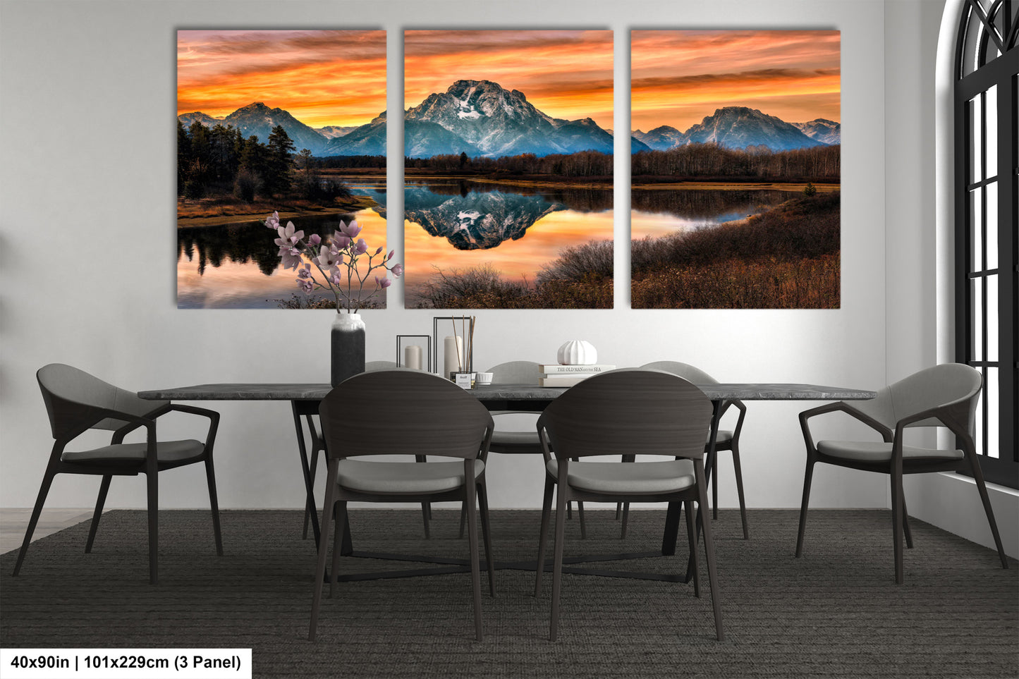 a dining room table with chairs and a painting on the wall