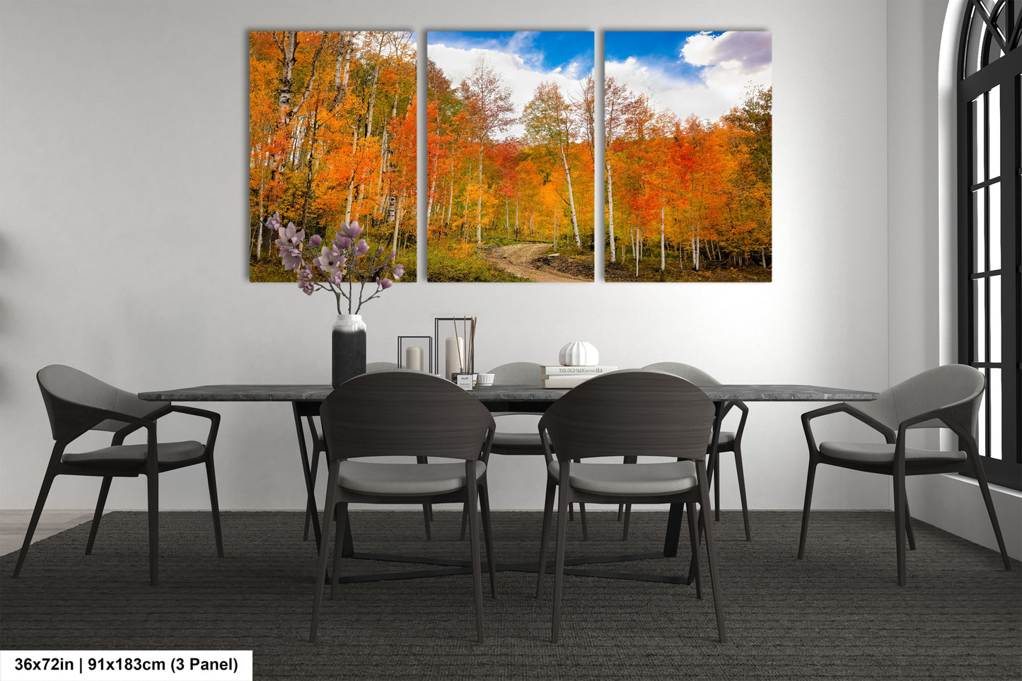 a dining room table with four chairs and a painting on the wall