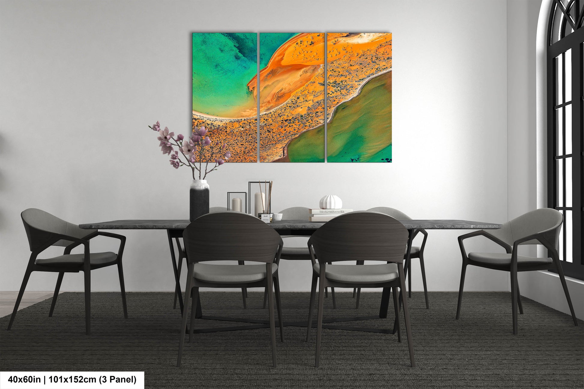 a dining room table with chairs and a painting on the wall