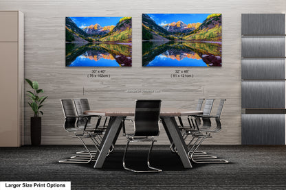 a dining room table with chairs and a painting on the wall