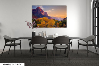 a dining room table with chairs and a painting on the wall