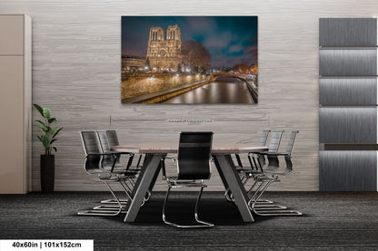 a dining room table with chairs and a painting on the wall