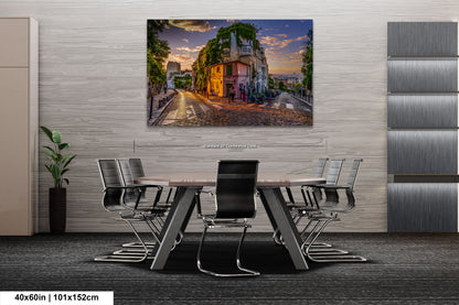 a dining room table with chairs and a painting on the wall