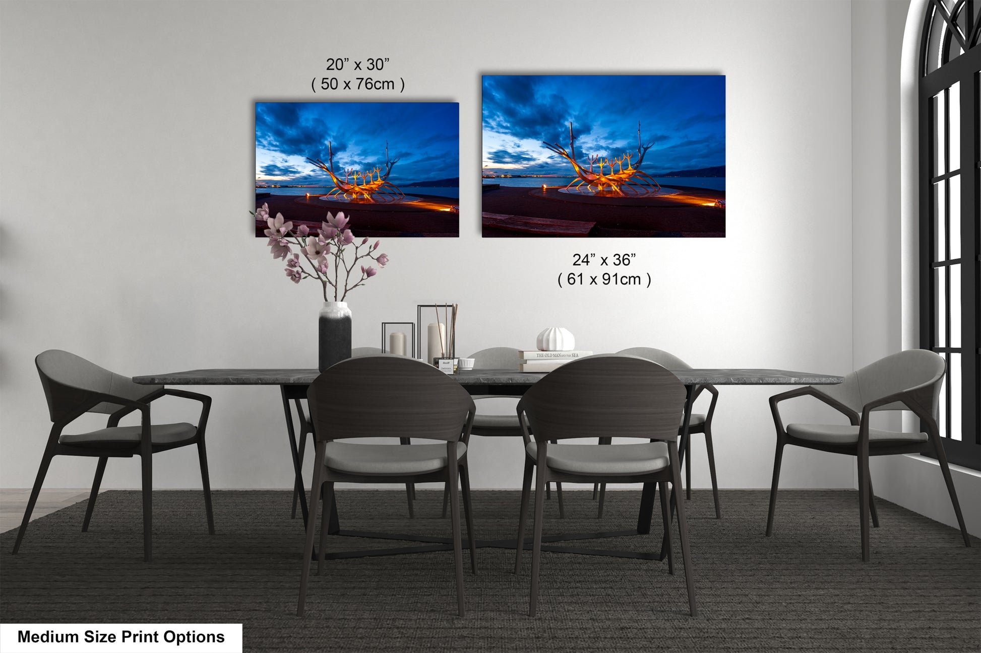 a dining table with four chairs and a vase of flowers