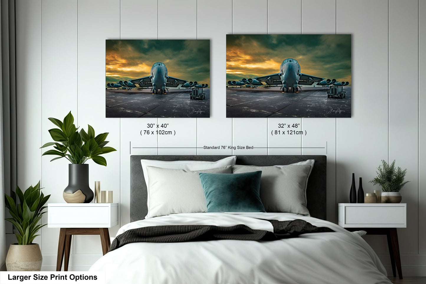 a bed with two pictures on the wall above it