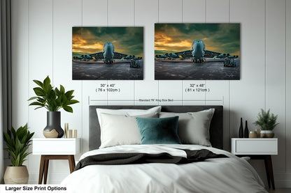 a bed with two pictures on the wall above it